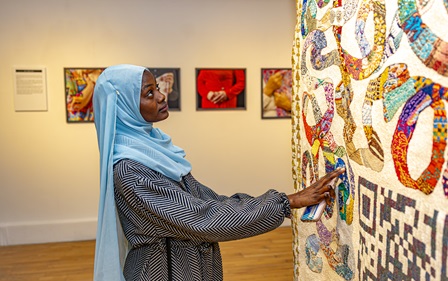 Woman gazing at tapestry